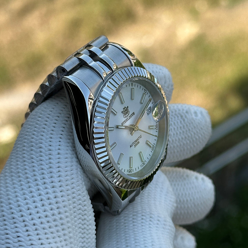 Steeldive SD1933 white dial 39mm dive watch held in gloved hand, three-quarter angle outdoor