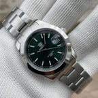 Steeldive SD1934 dive watch with black dial and jubilee bracelet on white wrist roll