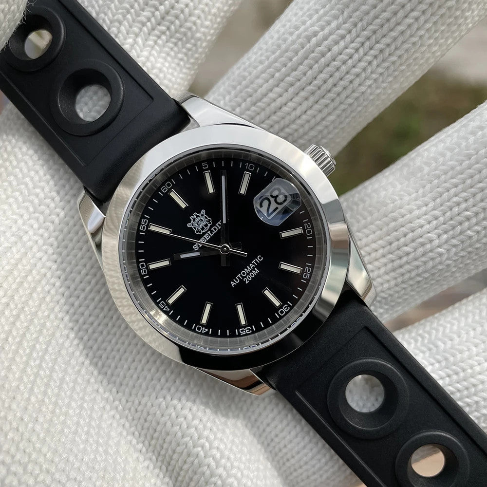Steeldive SD1934 dive watch with black dial and perforated black rubber rally strap on wrist roll