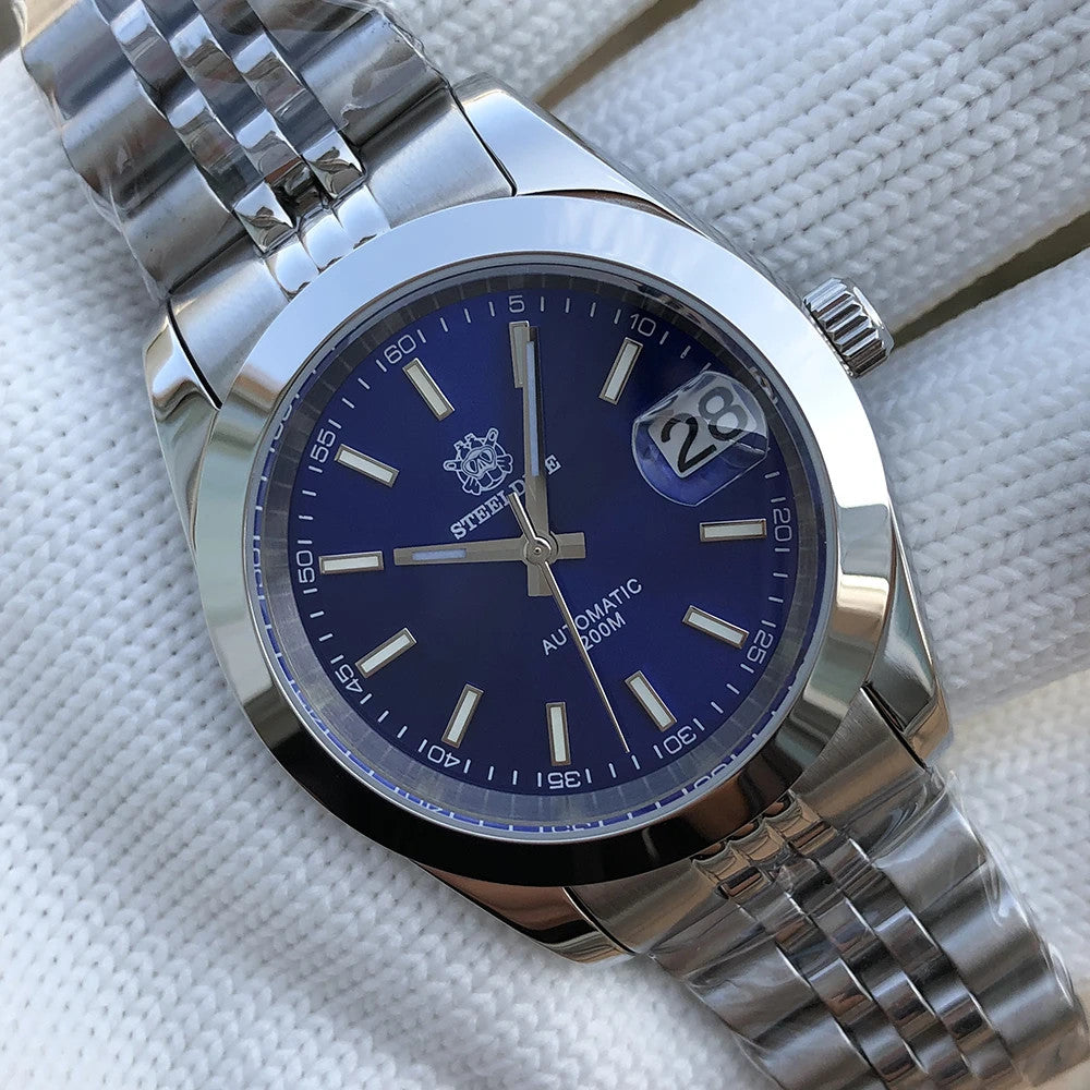 Steeldive SD1934 dive watch with blue sunburst dial and jubilee bracelet, angled view on towel