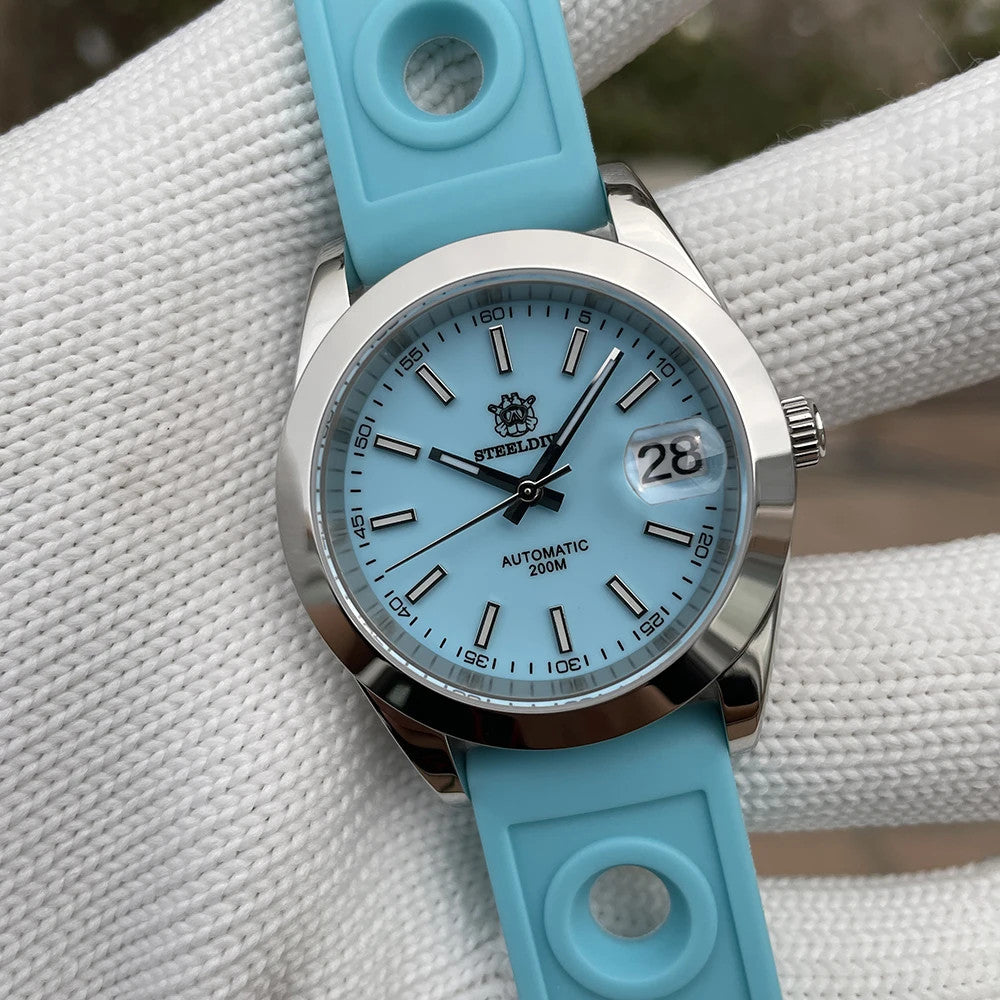Steeldive SD1934 dive watch with blue dial and blue perforated rubber rally strap on wrist roll