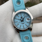 Steeldive SD1934 dive watch with blue dial and blue perforated rubber rally strap on wrist roll