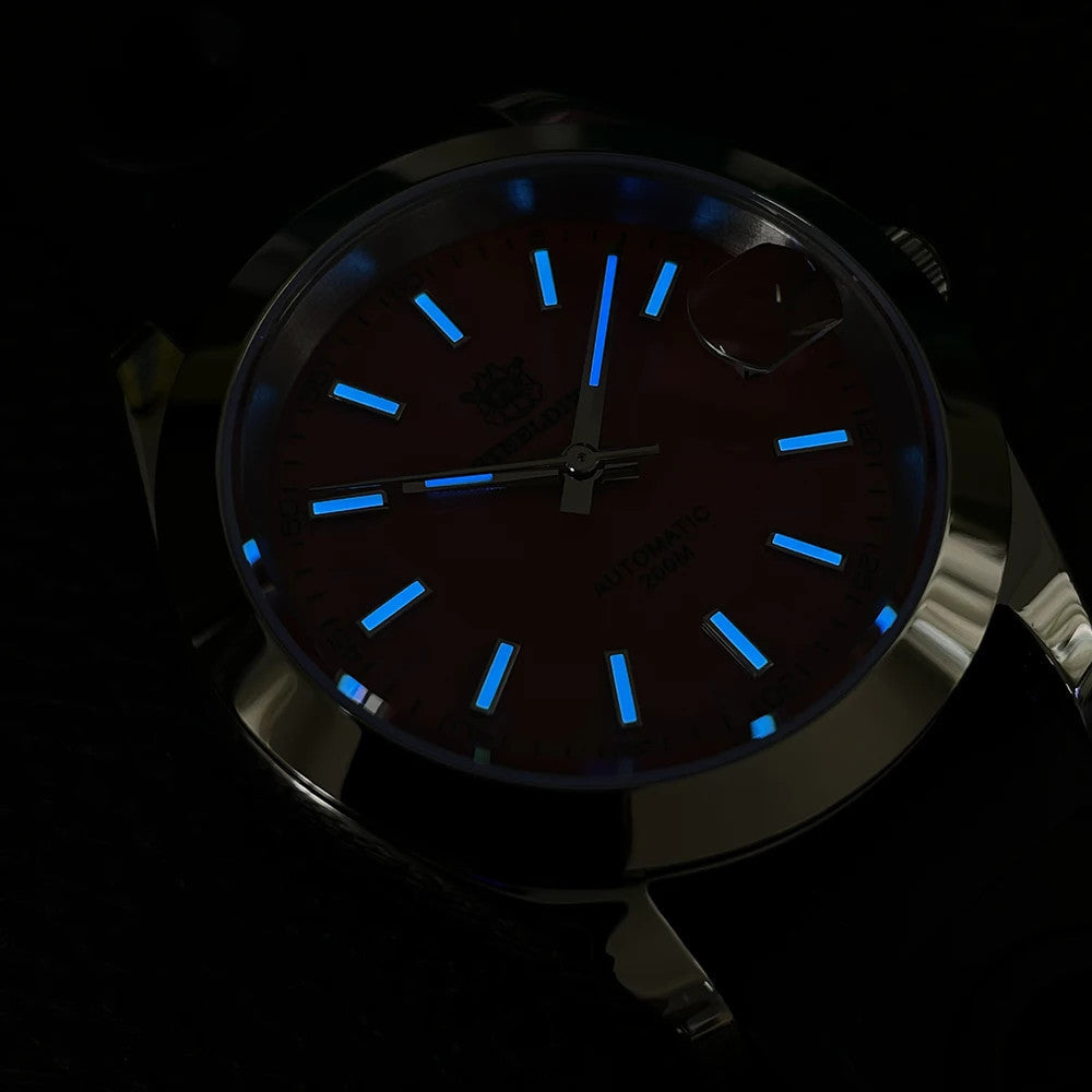 Steeldive SD1934 dive watch lume shot with blue glowing indices and hands in the dark