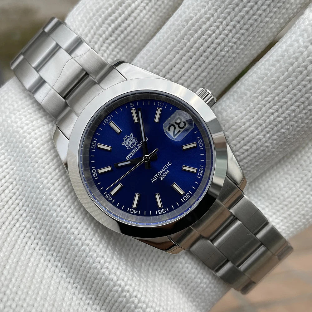 Steeldive SD1934 dive watch with green dial and jubilee bracelet angled on white wrist roll