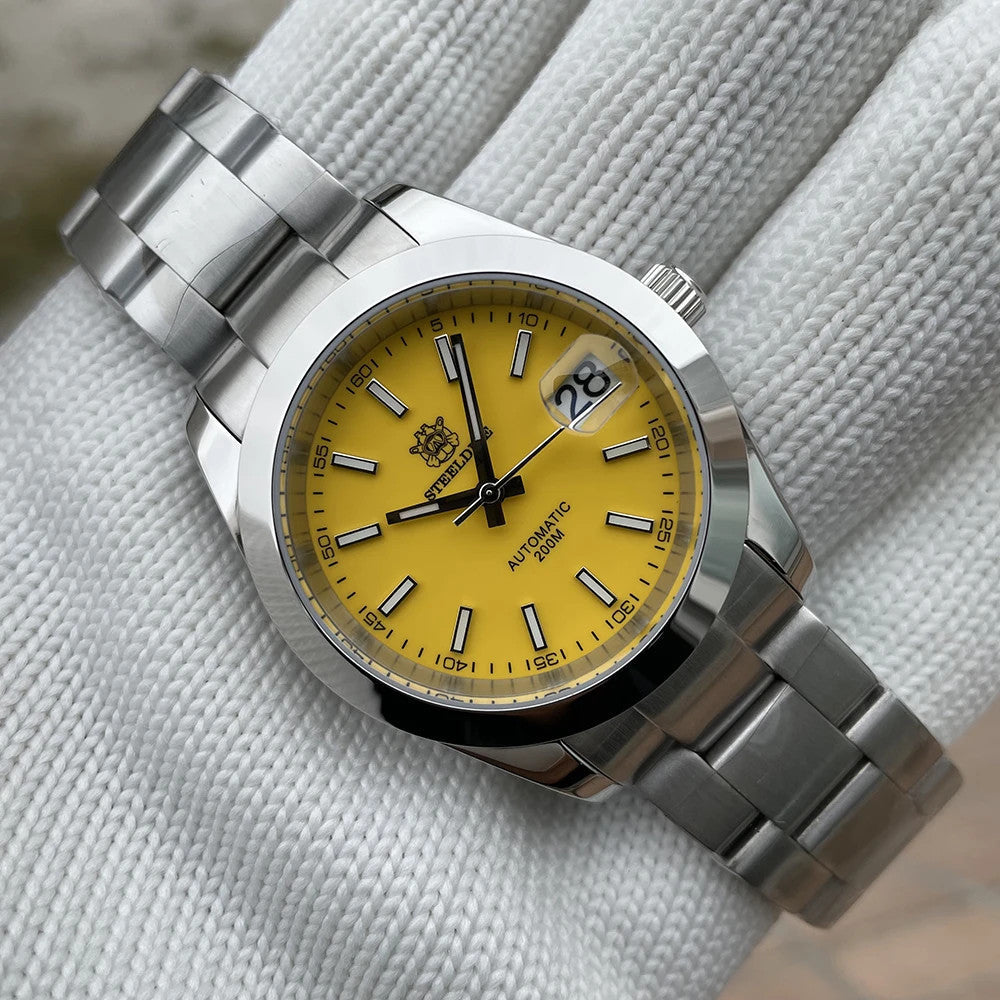 Steeldive SD1934 dive watch with green dial and oyster steel bracelet on wrist roll