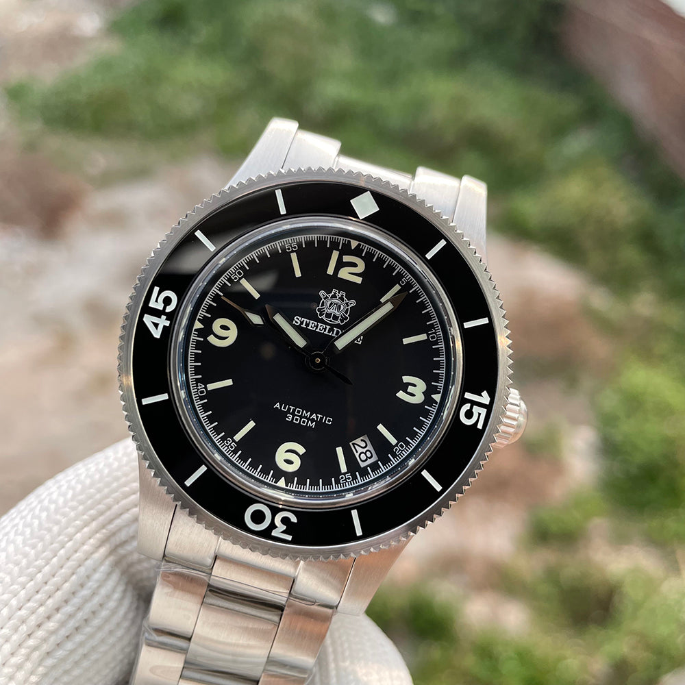 Steeldive SD1952 black dial fifty fathoms watch on steel bracelet, angled dial macro with date