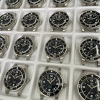Steeldive SD1952 fifty fathoms black dial dive watches lined up in factory tray, comparison overview
