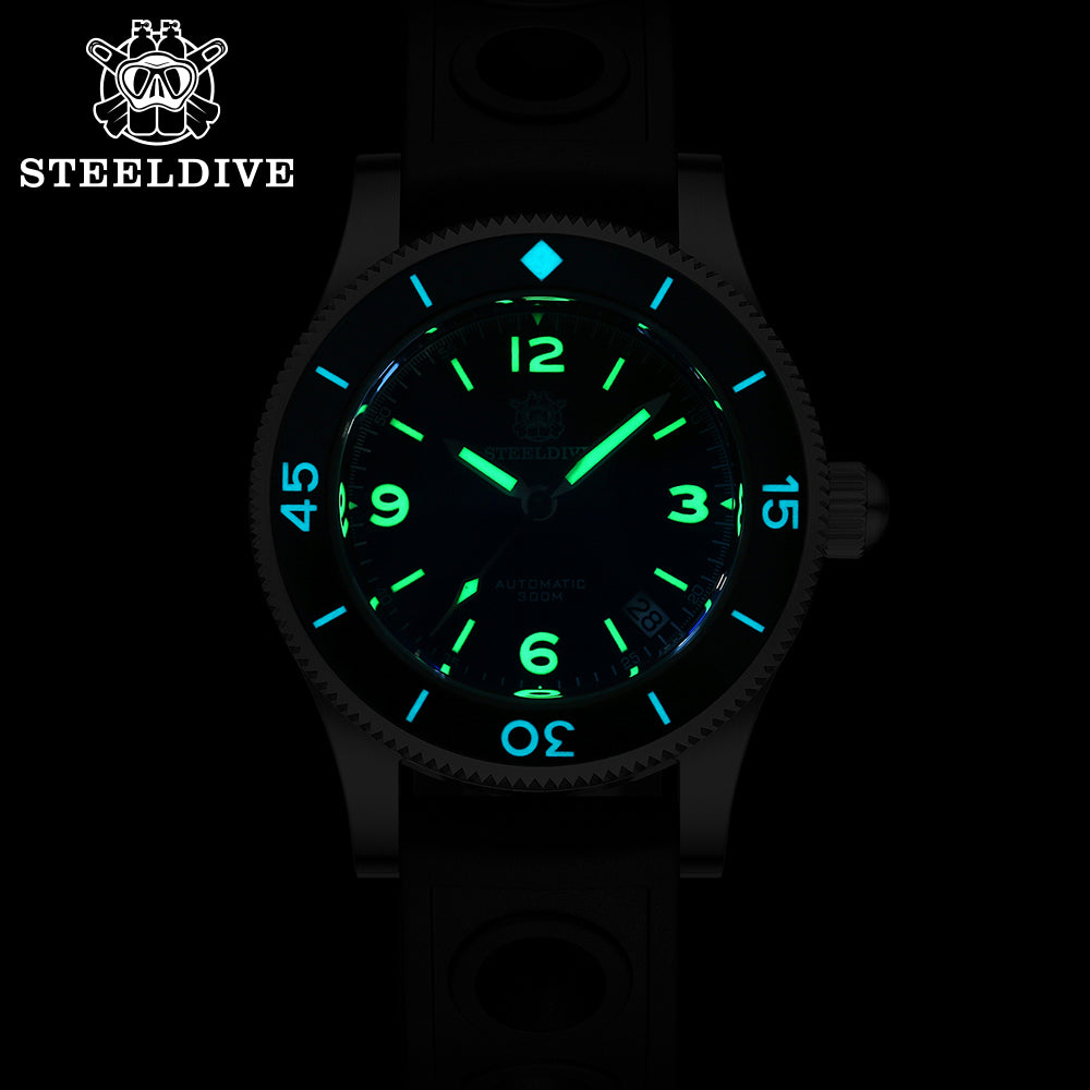 Steeldive SD1952 fifty fathoms watch glowing green and blue lume in the dark, date visible at 4:30