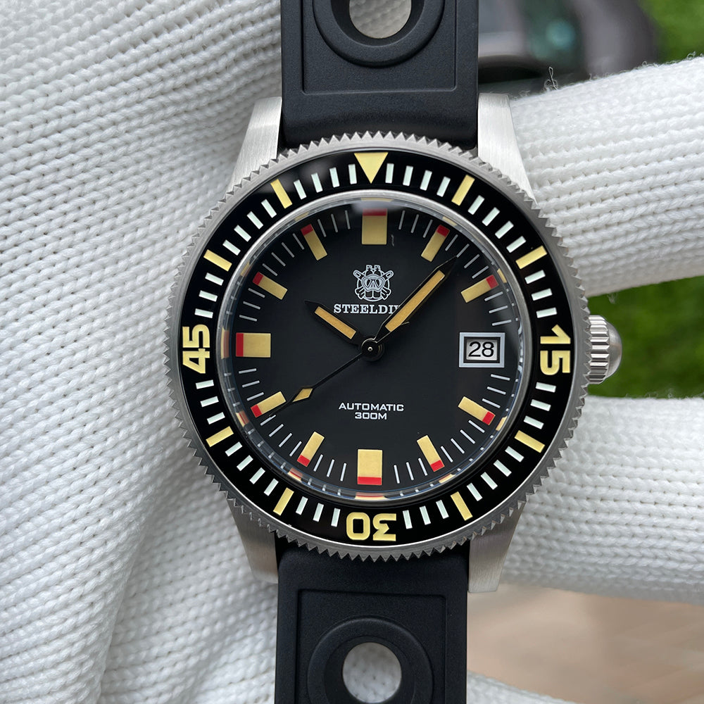 Steeldive SD1952T 300M dial macro detailing yellow lume indices, red accents and applied Steeldive crest