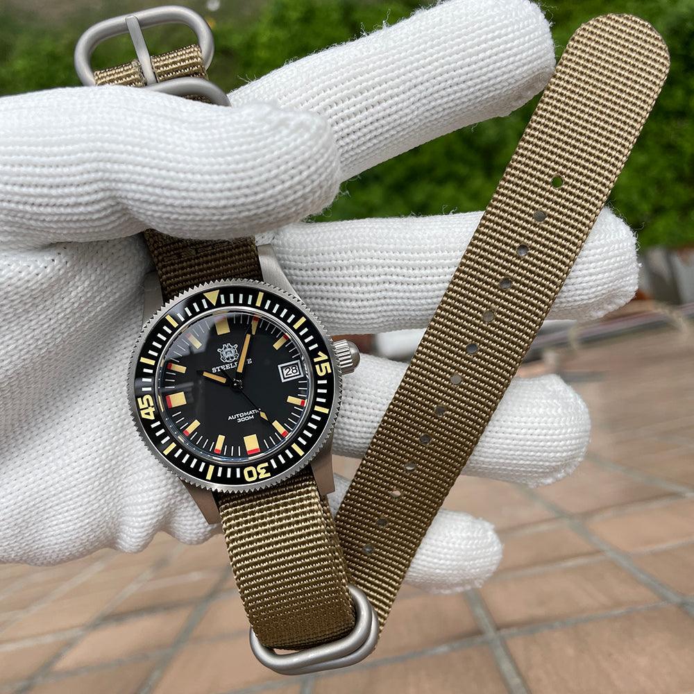 Steeldive SD1952T 300M on khaki single-pass nylon strap, lifestyle hand-held view
