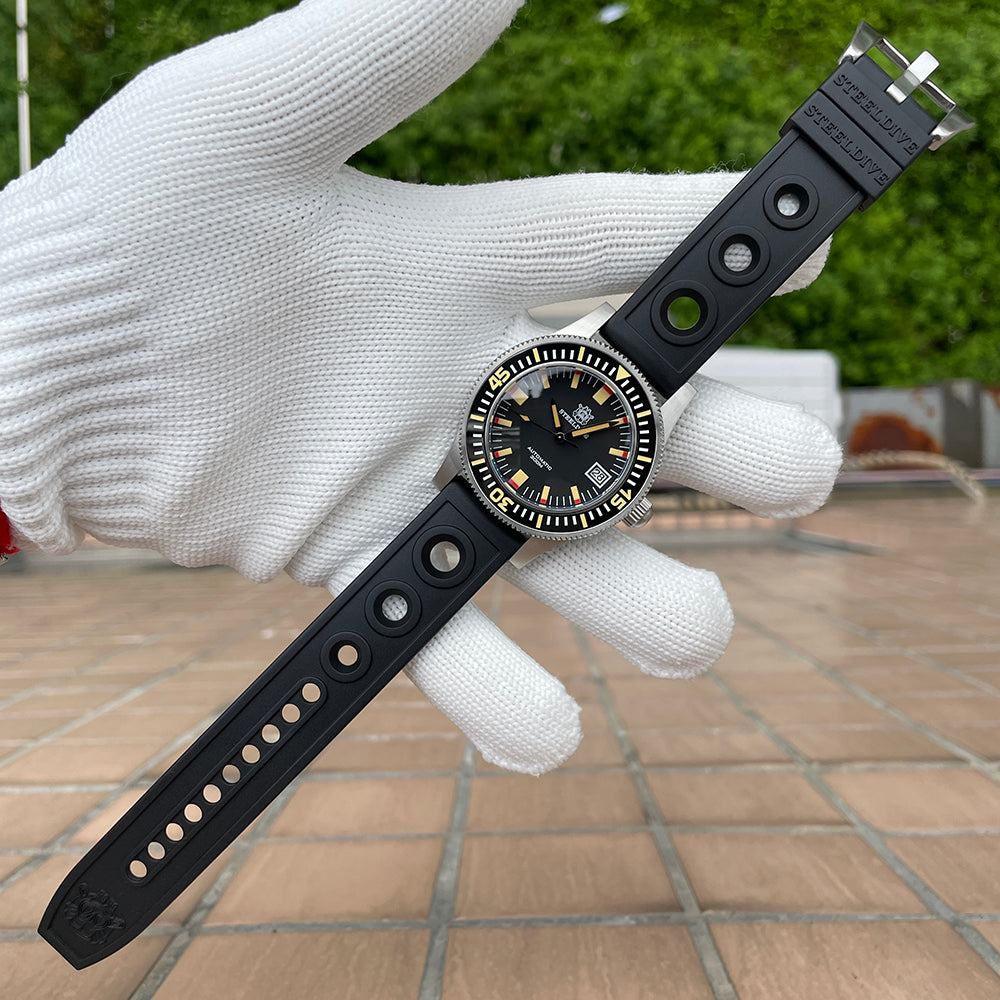 Steeldive SD1952T 300M with black perforated tropic rubber strap fully extended in hand