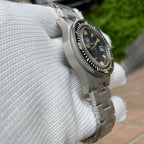 Steeldive SD1952T 300M diver angled wrist shot showing black dial, yellow lume indices and steel bracelet