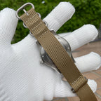 Steeldive SD1952T caseback view on khaki NATO strap, brushed steel case profile