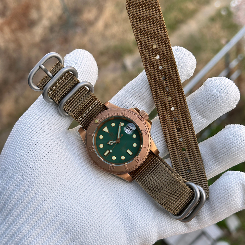 Steeldive SD1953S green dial bronze dive watch with monochrome bezel and khaki nylon NATO strap held on hand