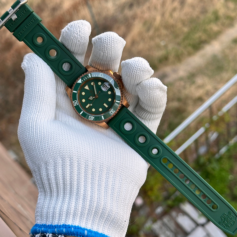 Steeldive SD1953S green dial bronze dive watch with green ceramic bezel and green rubber strap held on hand