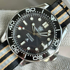 STEELDIVE SD1957L black dial dive watch on a black, grey and sand striped nylon strap