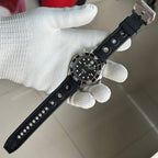 STEELDIVE SD1957L on a black perforated rubber strap held in a gloved hand