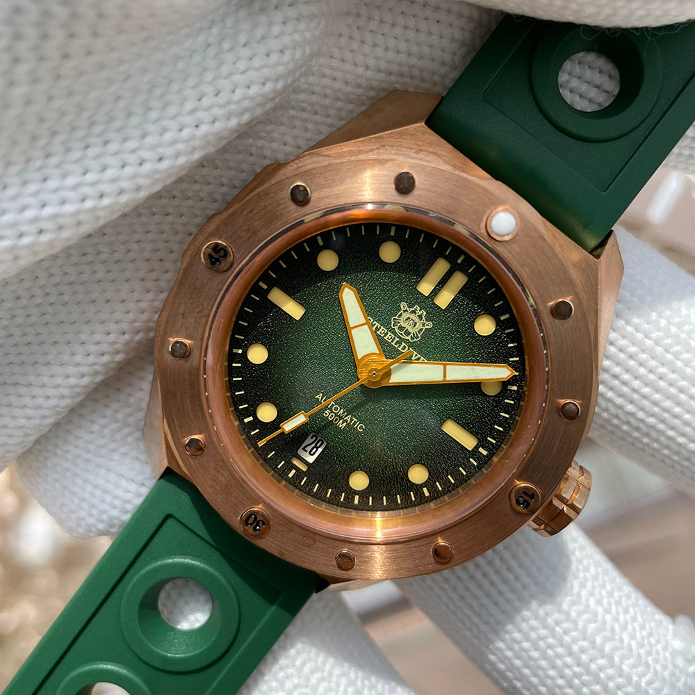 Steeldive SD1960S bronze 500m diver with green sunburst dial on white woven fabric backdrop