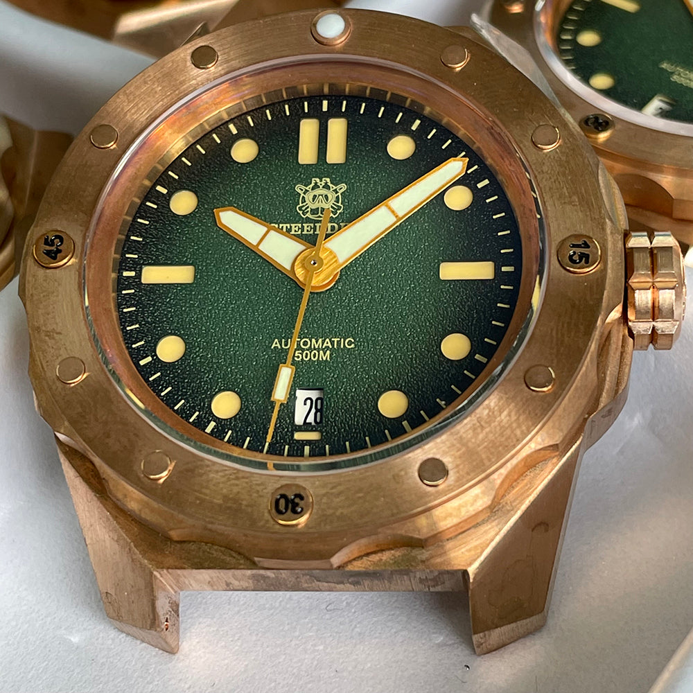 Steeldive SD1960S bronze dive watch macro of green sunburst dial cream lume indices and gold hands