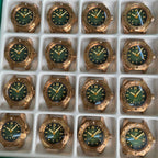 Steeldive SD1960S bronze green dial dive watch lineup in production tray showing patina variation