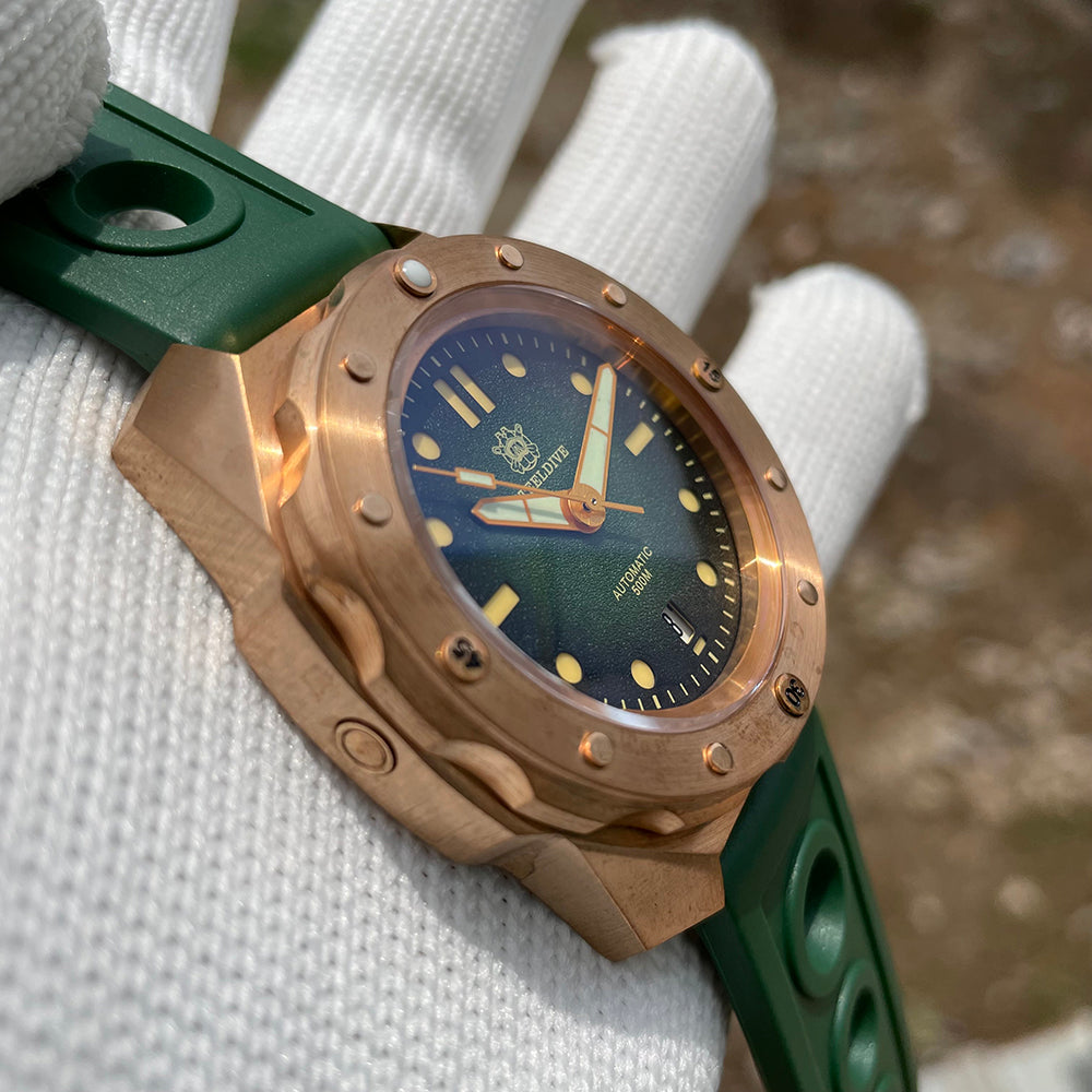 Steeldive SD1960S bronze 500m diver green dial on green rubber strap held in white dive glove