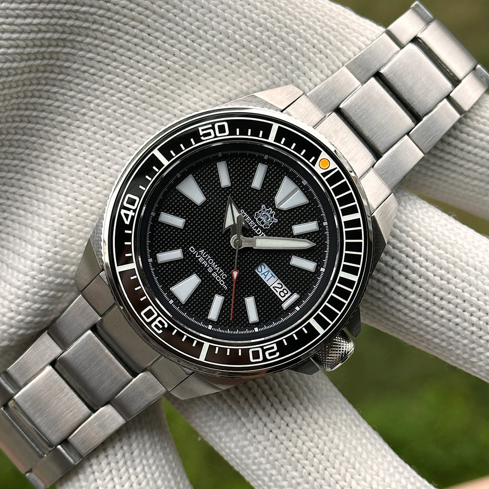 Steeldive SD1961 ceramic bezel insert installed on host SD1961 diver watch, angled view on bracelet