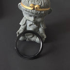 Steeldive SD1961 black ceramic bezel insert shown edge-on against figurine to highlight ring thickness