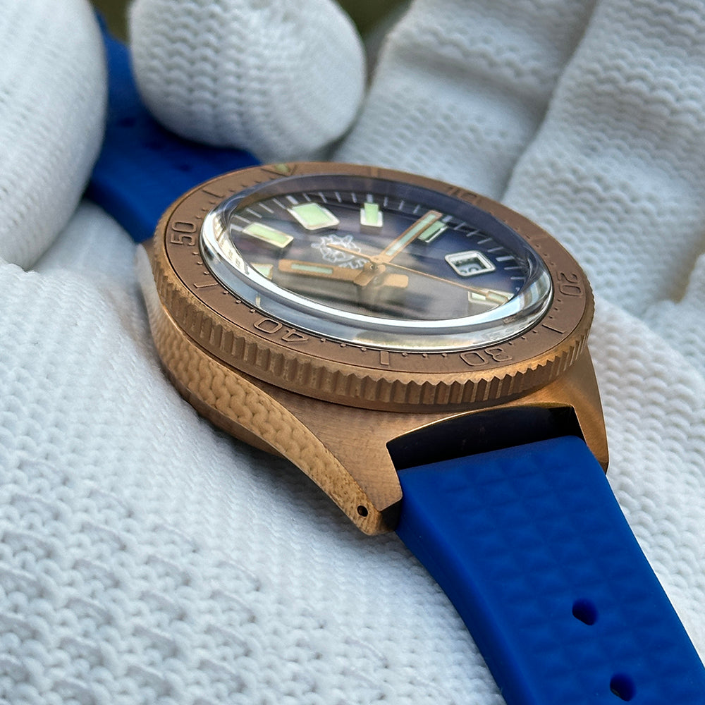 Steeldive SD1962S blue sunburst dial macro showing applied indices and domed crystal distortion