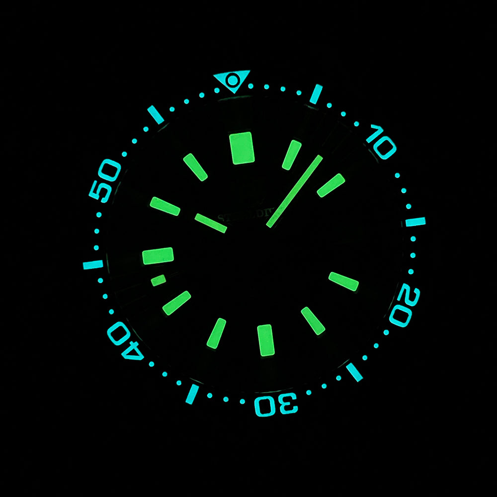 Steeldive SD1962S lume shot, blue bezel pip glow and green dial lume in darkness