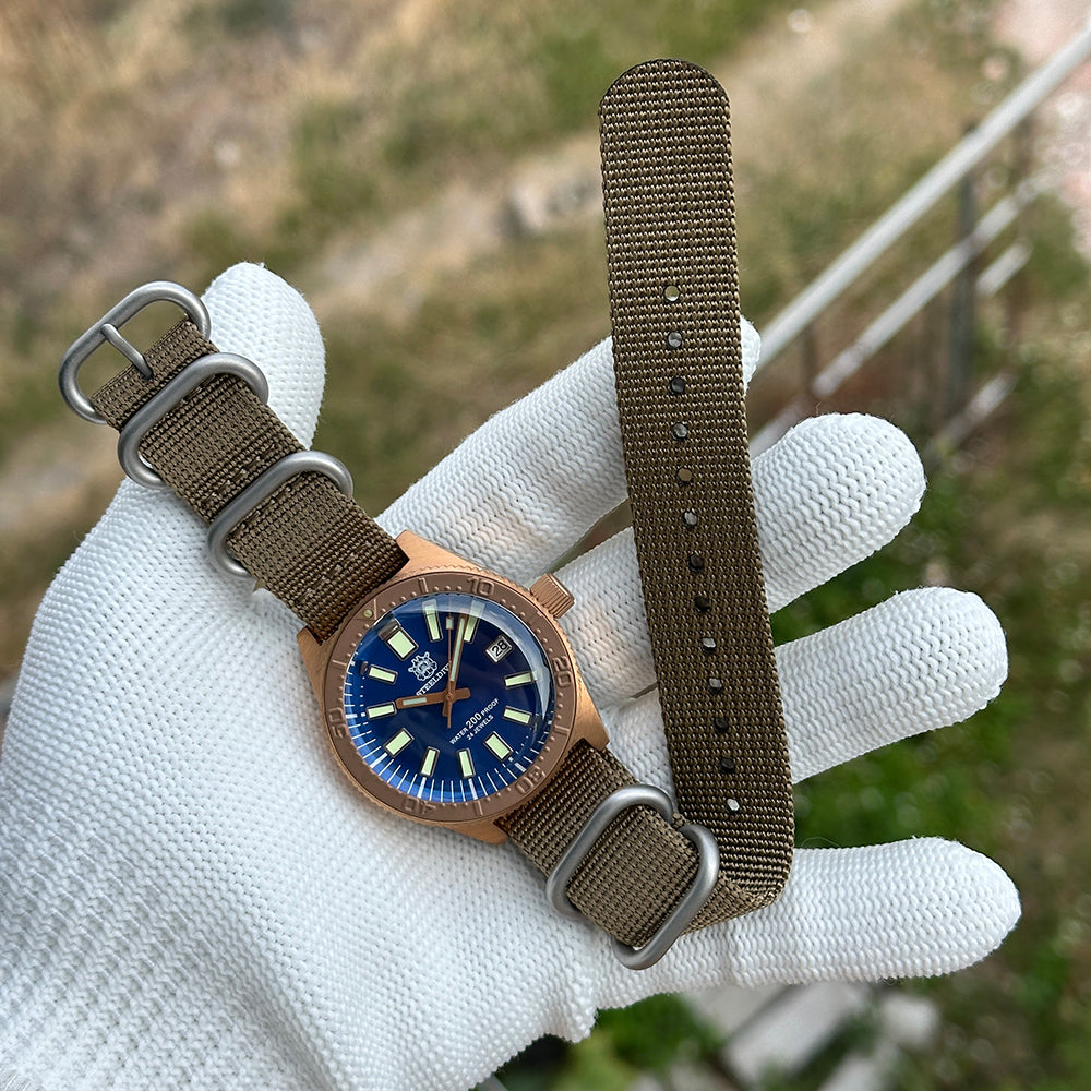 Steeldive SD1962S bronze dive watch on khaki zulu nato strap held in gloved hand, wrist-style view