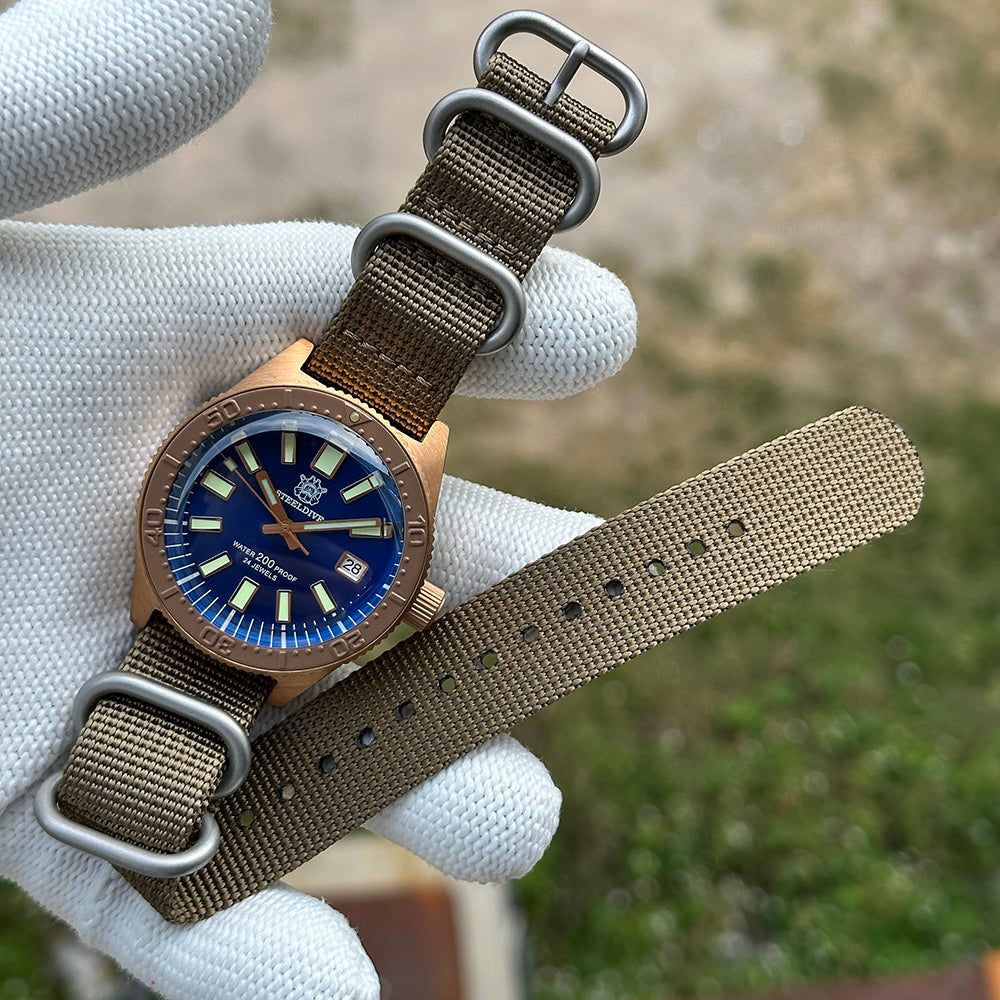 Steeldive SD1962S bronze watch on khaki zulu nylon strap with brushed hardware, flat layout