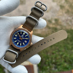 Steeldive SD1962S bronze watch on khaki zulu nylon strap with brushed hardware, flat layout