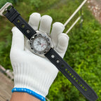Steeldive SD1964GMT white dial black bezel GMT on black rubber strap displayed in gloved hand outdoors