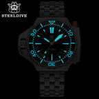 Steeldive SD1969 Proplof dive watch lume shot, cyan glowing indices and hands on black dial in the dark