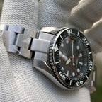 Steeldive SD1971GMT dive watch with black bezel on steel bracelet, angled side view