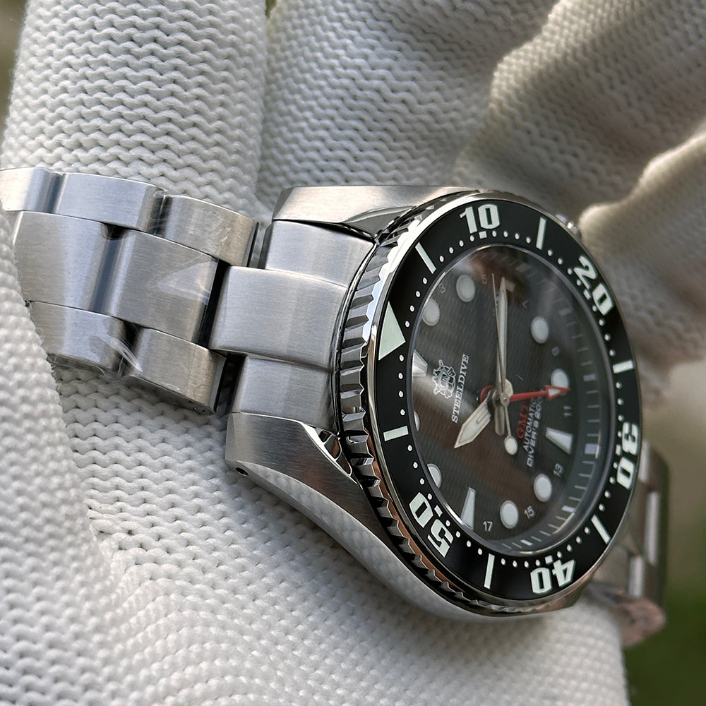 Steeldive SD1971GMT dive watch with black bezel on steel bracelet, angled side view