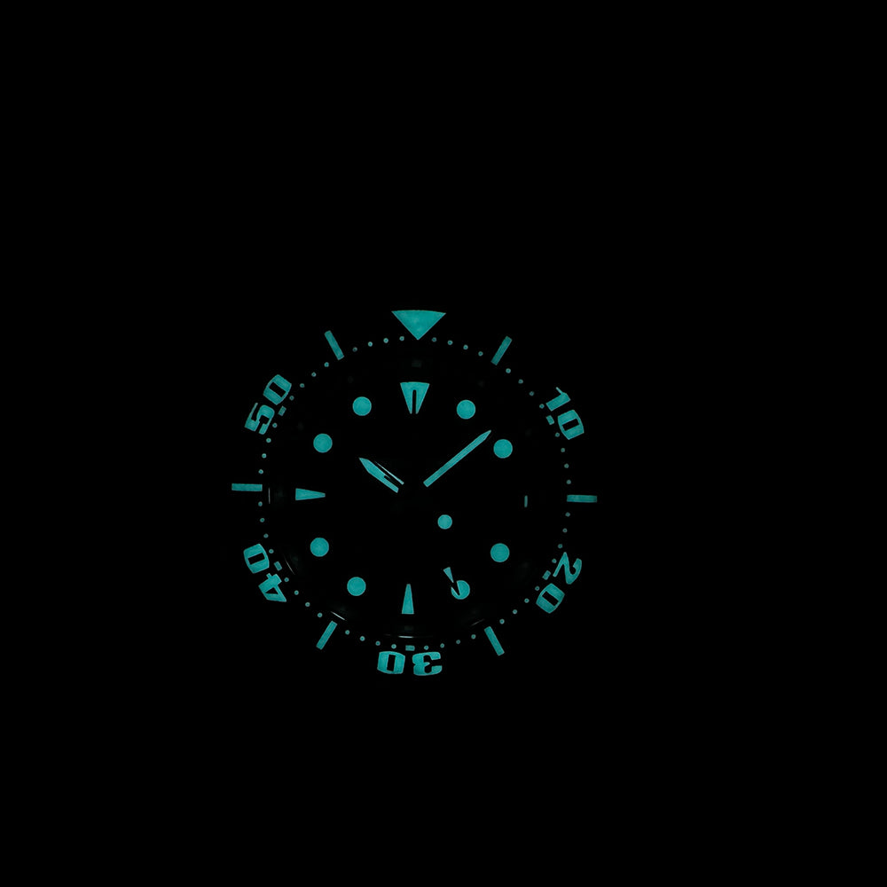 Steeldive SD1971GMT dive watch glowing blue lume on indices and bezel pip, dark lume shot