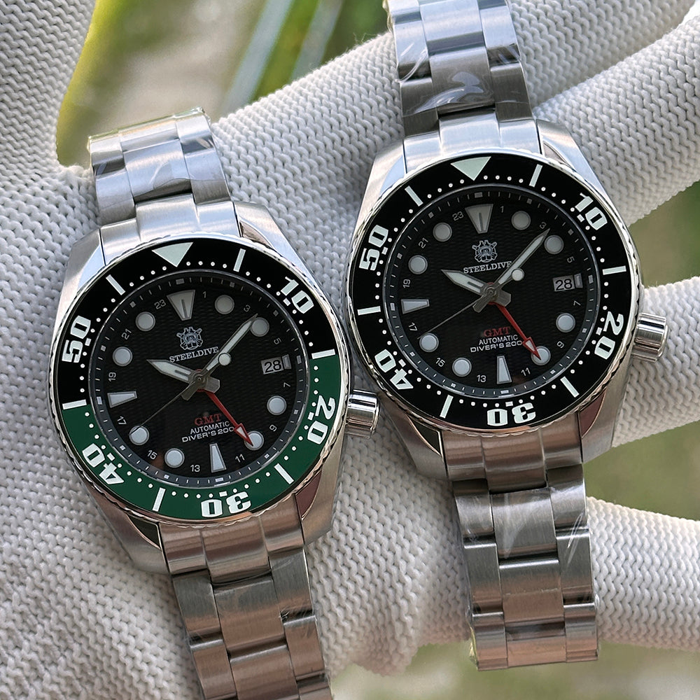 Steeldive SD1971GMT green bezel and black bezel variants on steel bracelets side by side