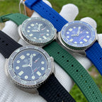 Steeldive SD1972 turtle diver trio flatlay showing black, green and blue variants on rubber straps