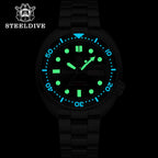 Steeldive SD1972 turtle diver lume shot showing green and blue luminous indices and hands in the dark