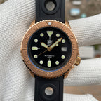 Steeldive SD1973S bronze case watch on black rubber strap, dial closeup with gilt arrow seconds hand