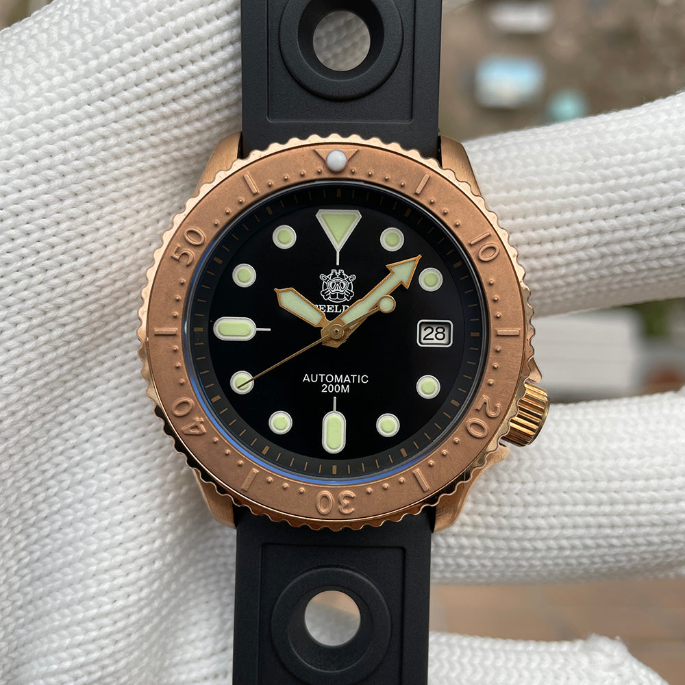 Steeldive SD1973S bronze case watch on black rubber strap, dial closeup with gilt arrow seconds hand