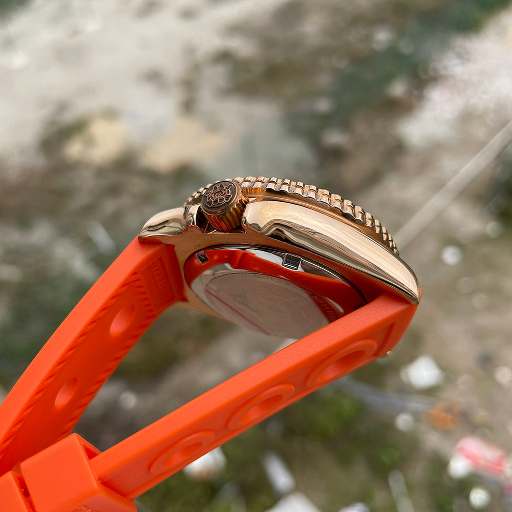 Steeldive SD1973S bronze case side profile with orange rubber strap, polished crown and bezel coin edge