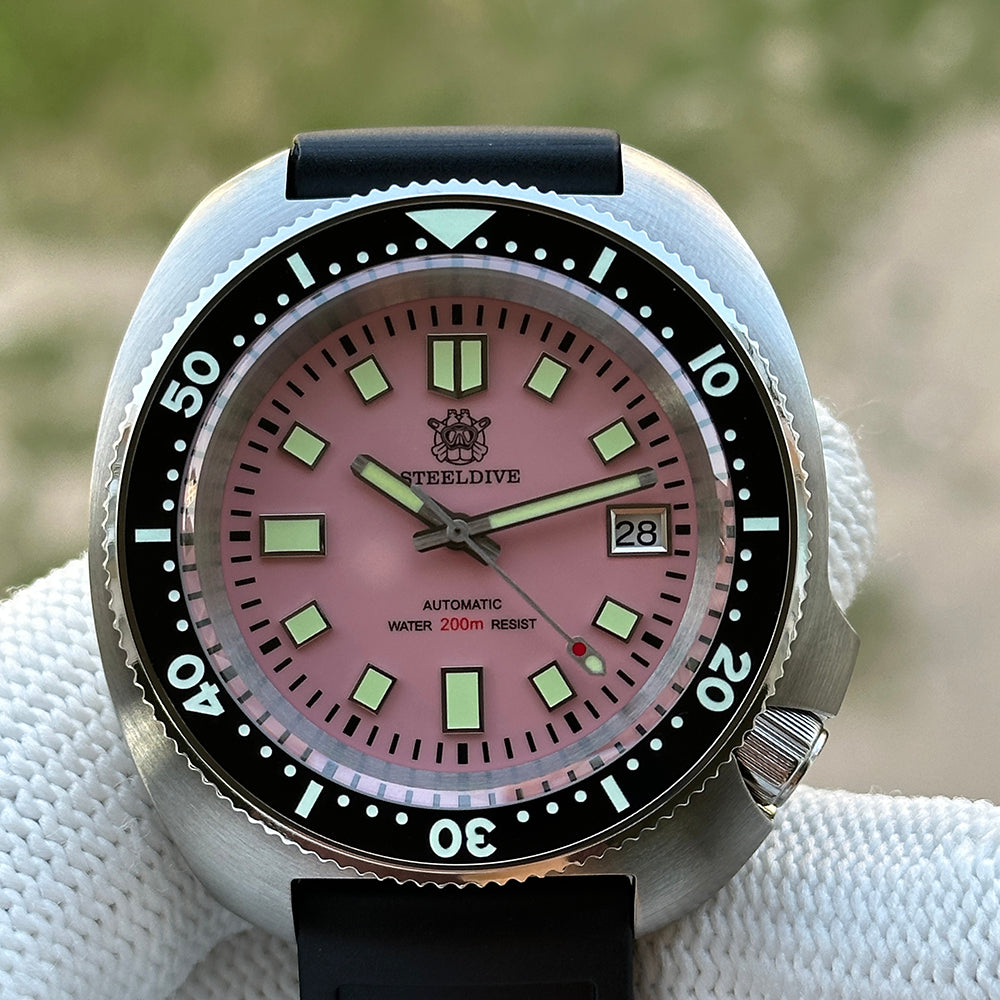 Steeldive SD1974 turtle case pink dial on black rubber dive strap, front macro