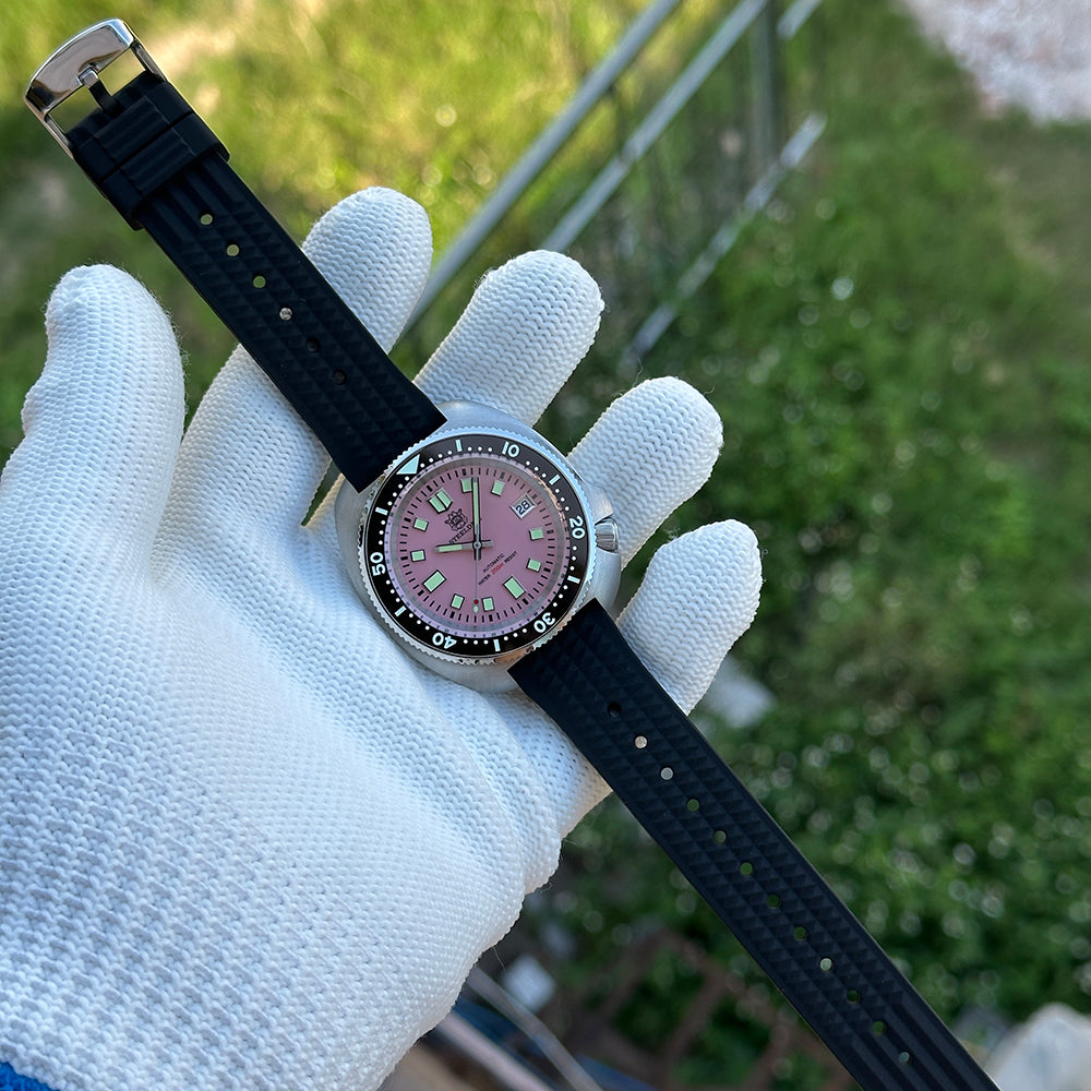 Steeldive SD1974 turtle dive watch pink dial worn on hand with rubber strap, lifestyle
