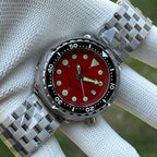 Steeldive SD1975 red sunray dial on jubilee bracelet, angled outdoor lifestyle shot