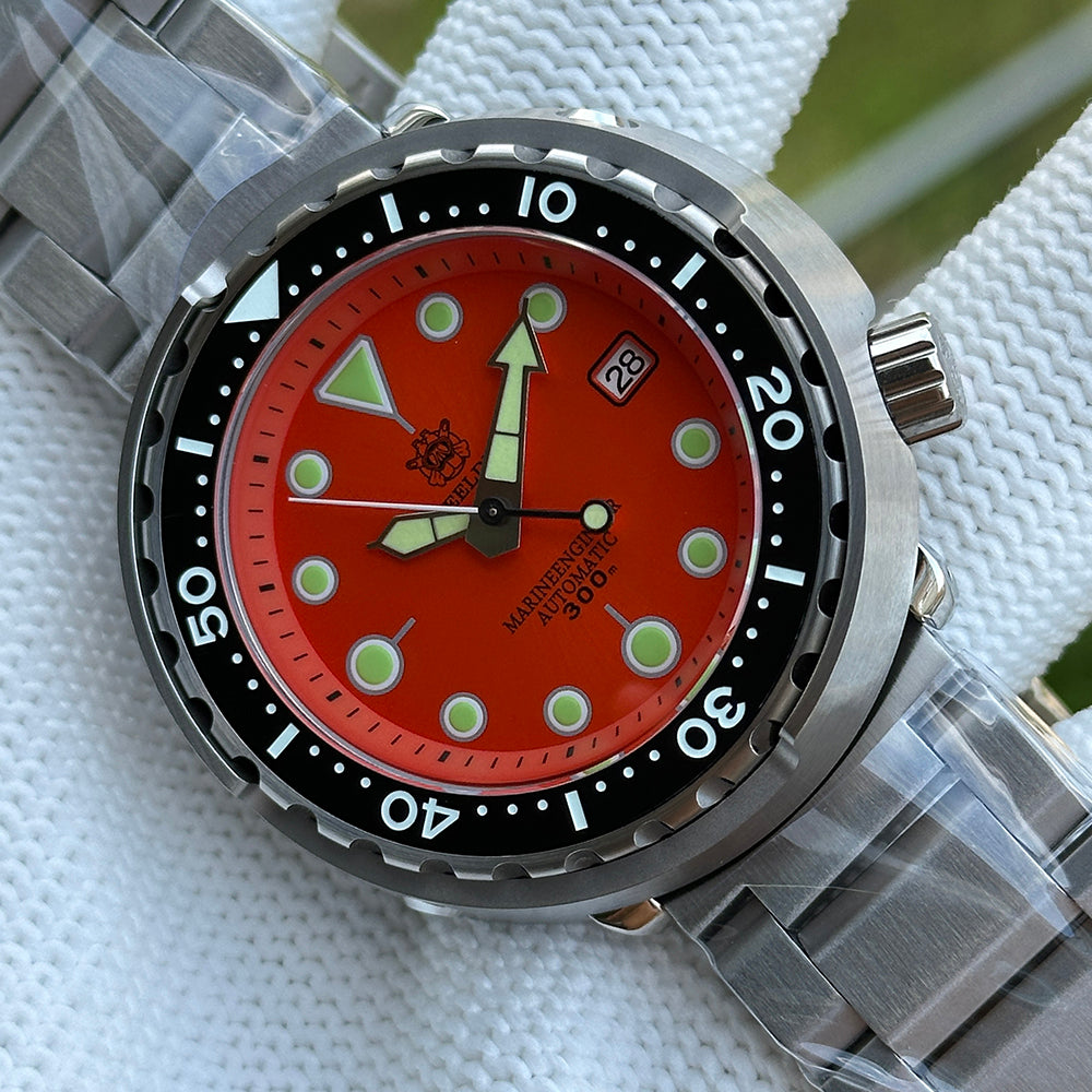 Steeldive SD1975 tuna watch close-up of matte orange dial on brushed stainless steel bracelet