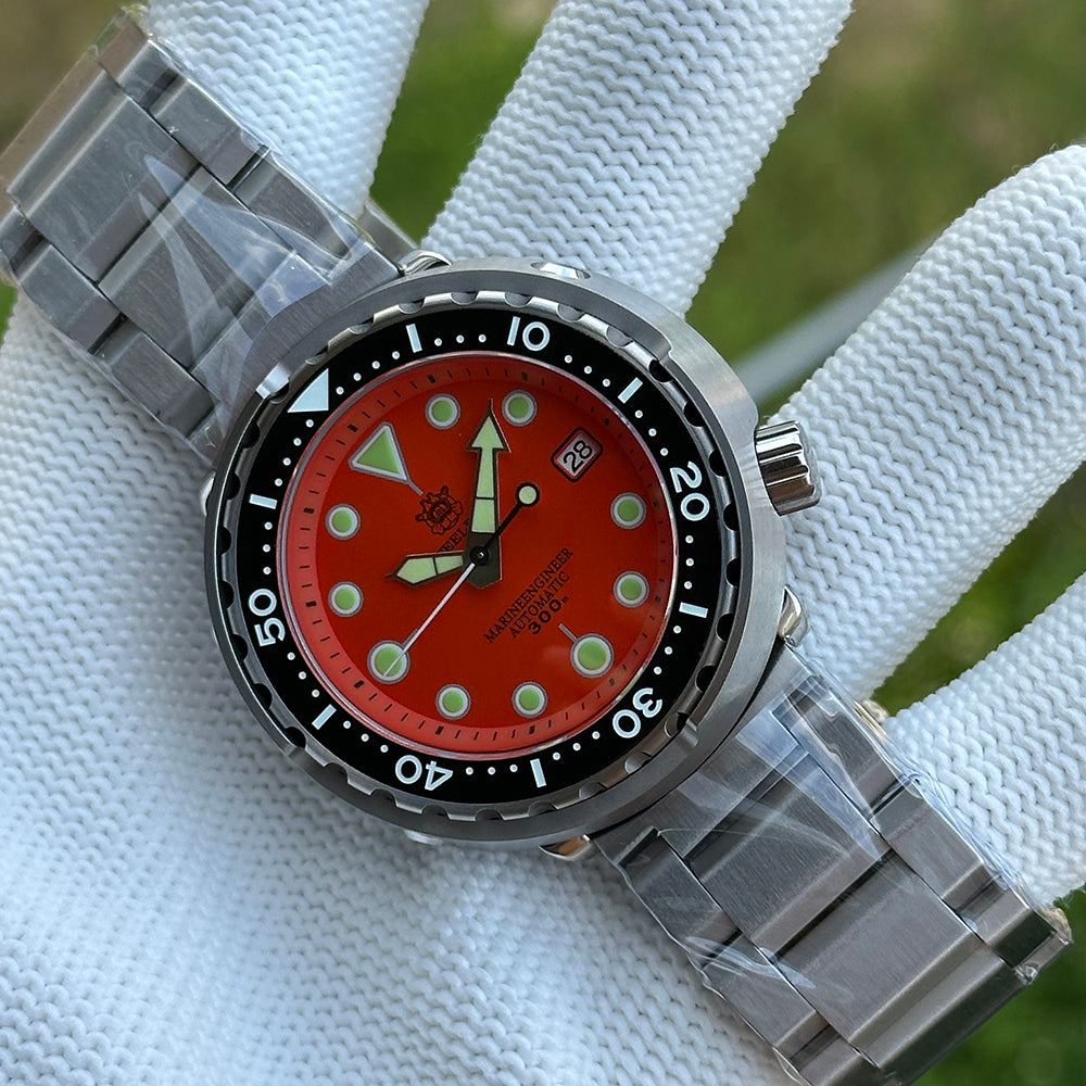 Steeldive SD1975 tuna dial macro showing matte orange face, applied lume dots and date window