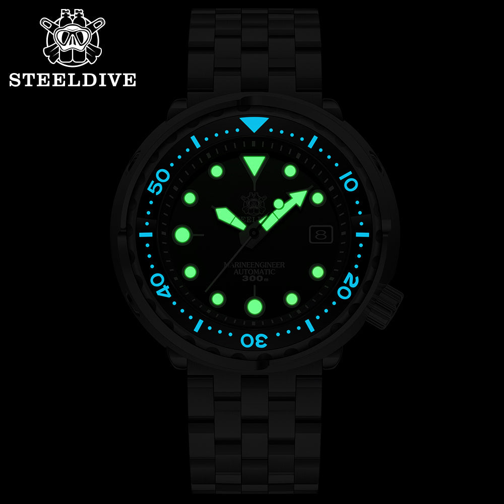 Steeldive SD1975 tuna watch lume shot with glowing green indices and blue bezel markers in dark