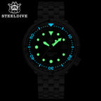 Steeldive SD1975 tuna watch lume shot with glowing green indices and blue bezel markers in dark